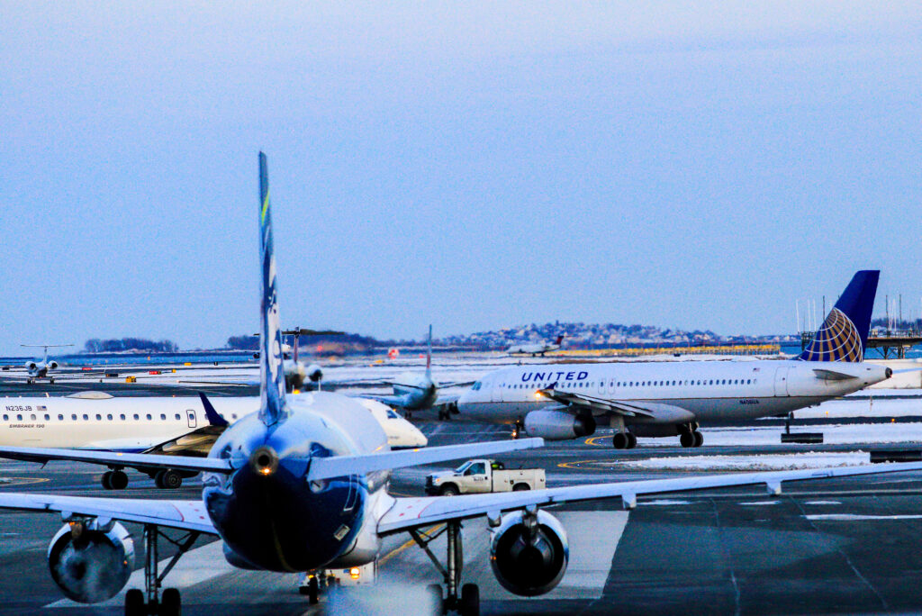 Airplanes from different Airlines lined up for take-off from Boston Logan International Airport after snow.