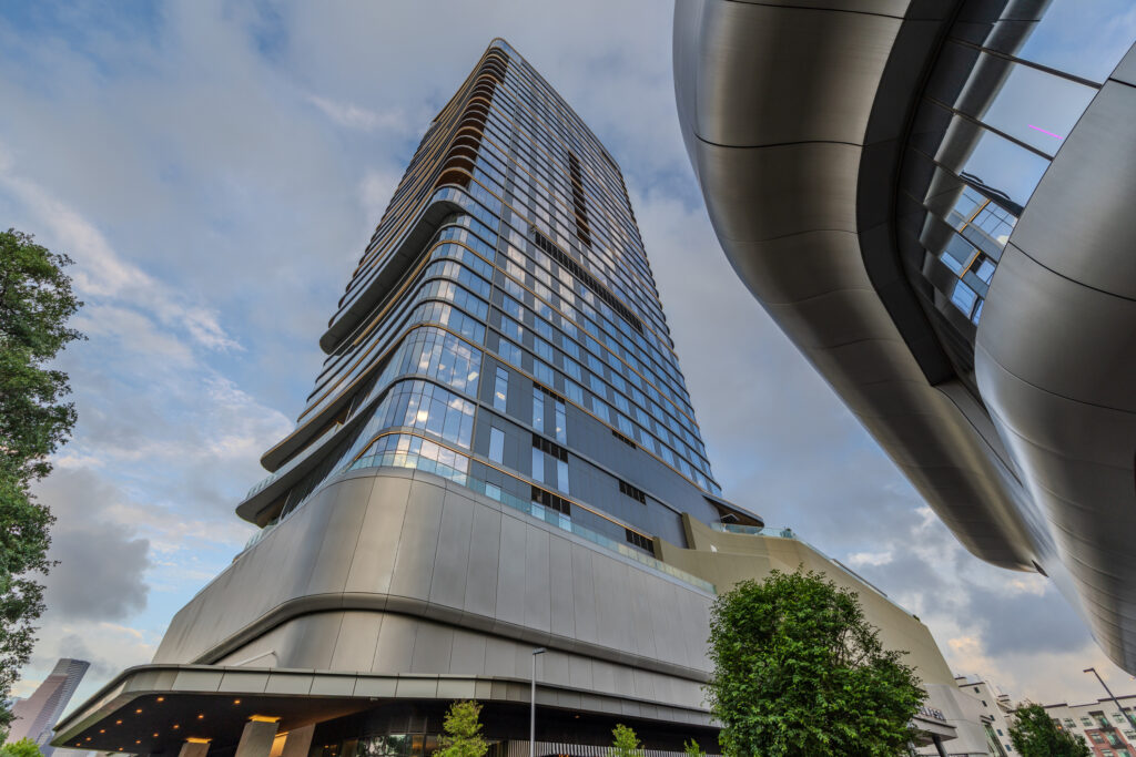 The 2-year new Thompson Houston, by Hyatt, hotel tower in a cloudy afternoon.