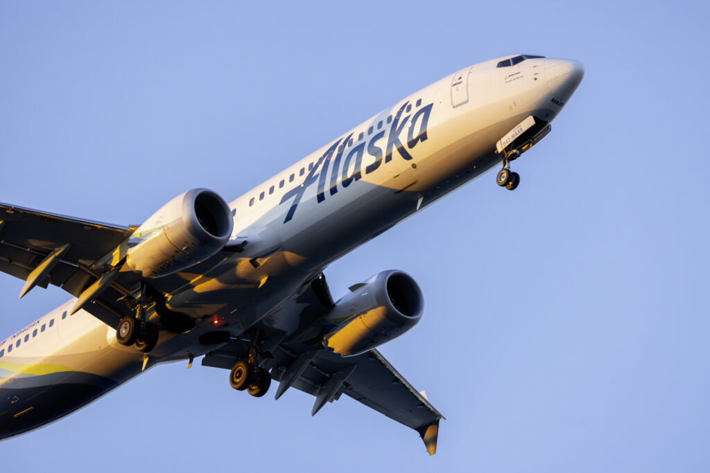 Portland, Oregon, USA - February 27, 2025: An Alaska Airlines 737 landing at PDX at sunset.