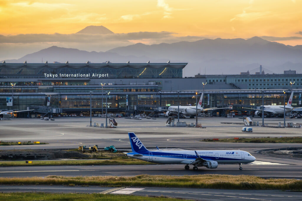 ANA Aircraft taxiing on the runway of Haneda International Airport with Fuji Mountain Background, Tokyo